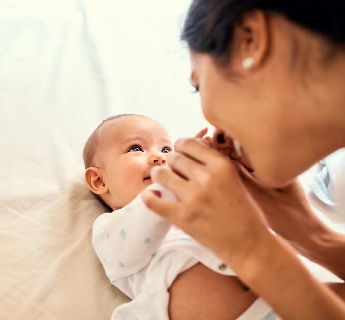 Mother playing with the hands of a baby