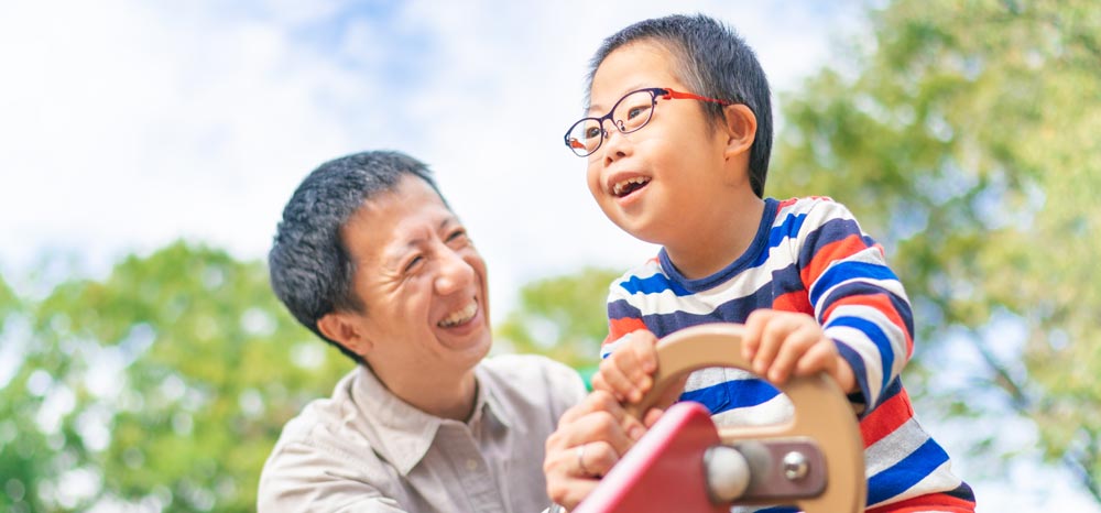 Father and special needs child playing - Special needs dentistry Kenosha, WI